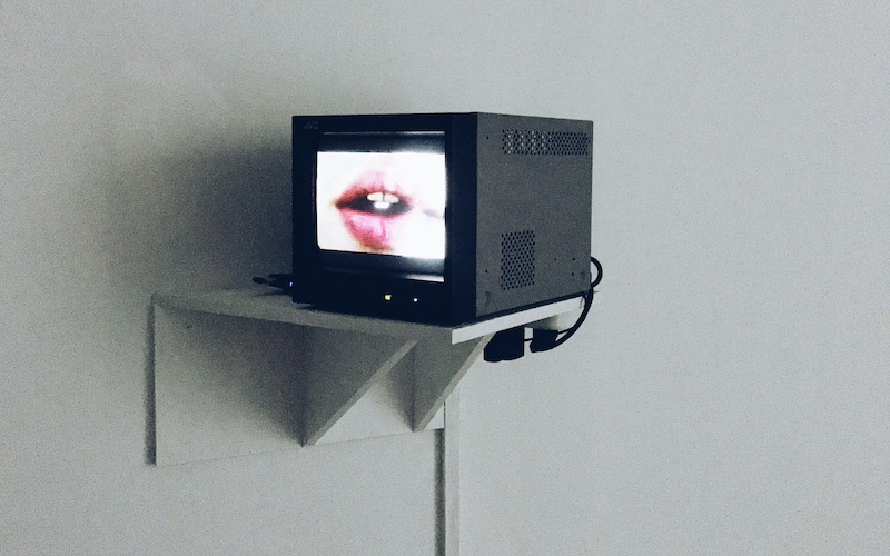 Black box mounted to the wall holds a screen that displays an open mouth