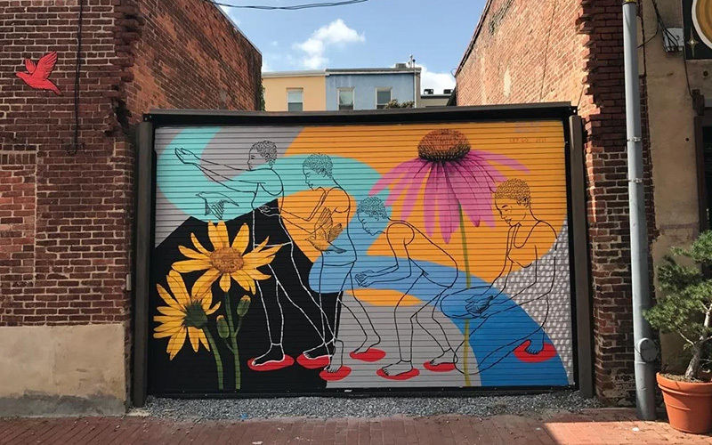 A mural on a garage on a city street
